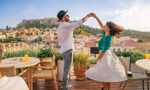 Couple having fun on a rooftop in Athens, Greece
